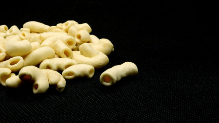 Macaroni snack isolated on black background
