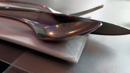 Fork spoon knife for cutlery on tissue on dining table