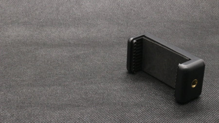 Tripod U holder for smart phone and camera isolated on black background