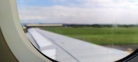 The view outside the plane if you look from the window, you can see green land.
