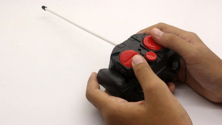 Remote control toy car playing with hands isolated on white background