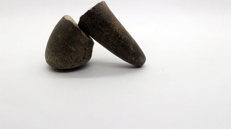 Broken stone grinder, hand grinder made of broken stone with a white background.