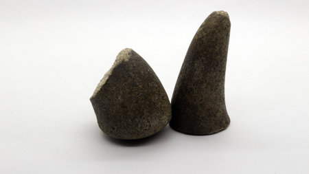 Broken stone grinder, hand grinder made of broken stone with a white background.