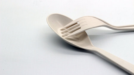 White plastic spoon and fork isolated on white background