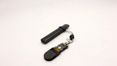 Black vape or electronic cigarette with hanger, white background