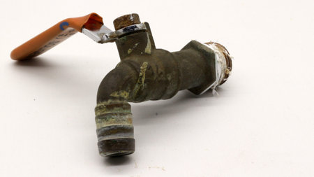 Broken and rusty water tap with white background