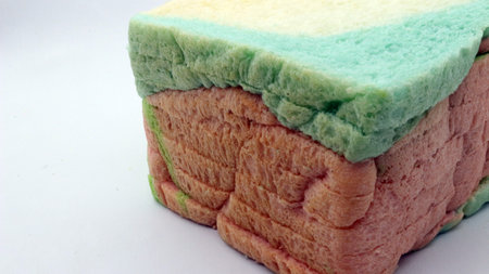 Sliced rainbow bread isolated on white backgroundの写真素材