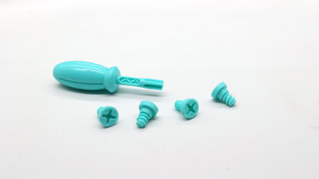 Blue screwdriver toy and screws isolated on white backgroundの写真素材
