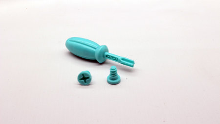 Blue screwdriver toy and nuts isolated on white backgroundの写真素材