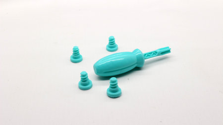 Blue screwdriver toy and nuts isolated on white backgroundの写真素材