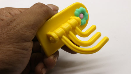 Plastic yellow hanging toy isolated on white backgroundの写真素材