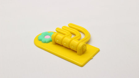 Plastic yellow hanging toy isolated on white backgroundの写真素材