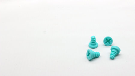 Blue screwdriver toy and nuts isolated on white backgroundの写真素材