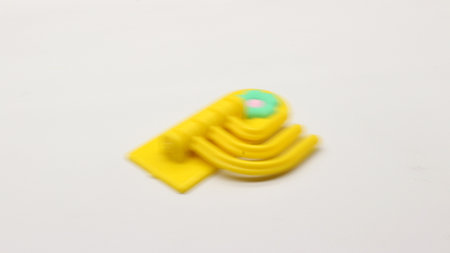 Plastic yellow hanging toy isolated on white backgroundの写真素材