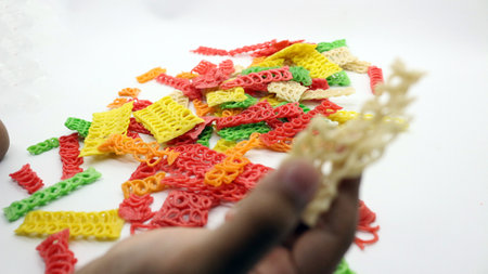 Colorful crackers or unfried isolated on white backgroundの写真素材