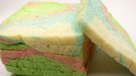 Sliced rainbow bread isolated on white backgroundの写真素材