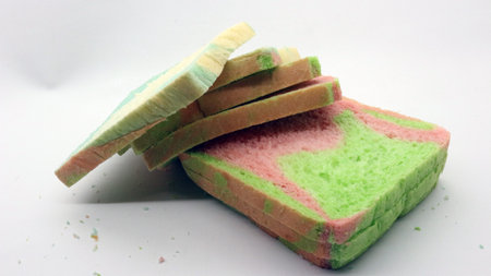 Sliced rainbow bread isolated on white backgroundの写真素材