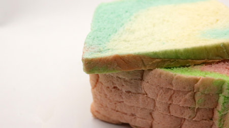 Sliced rainbow bread isolated on white backgroundの写真素材