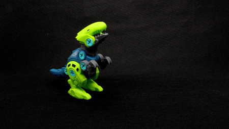 Dinosaur toy isolated on black backgroundの写真素材