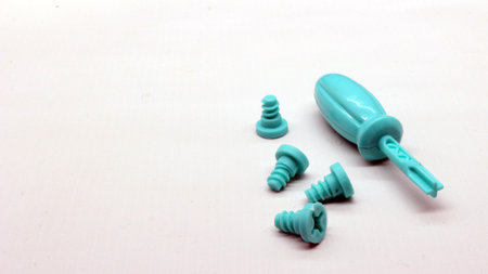 Blue screwdriver toy and nuts isolated on white backgroundの写真素材