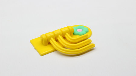 Plastic yellow hanging toy isolated on white backgroundの写真素材