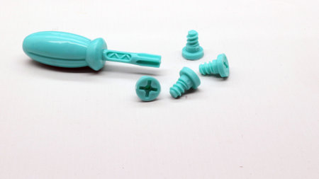 Blue screwdriver toy and nuts isolated on white backgroundの写真素材