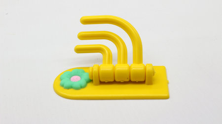 Plastic yellow hanging toy isolated on white backgroundの写真素材