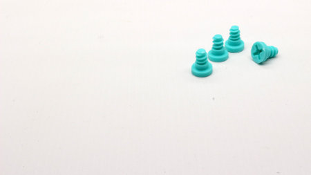 Blue screwdriver toy and nuts isolated on white backgroundの写真素材