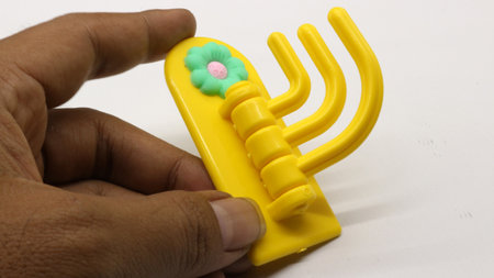 Plastic yellow hanging toy isolated on white backgroundの写真素材