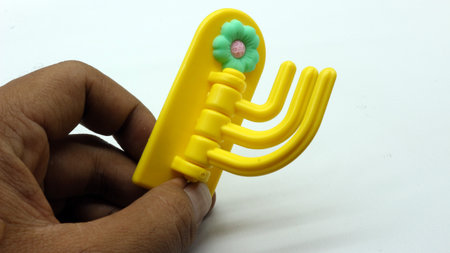 Plastic yellow hanging toy isolated on white backgroundの写真素材