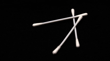 Cotton swabs for cleaning ears isolated on black backgroundの写真素材