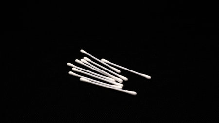 Cotton swabs for cleaning ears isolated on black backgroundの写真素材