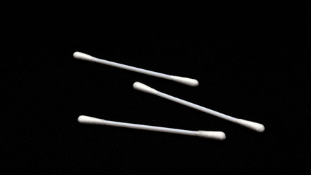 Cotton swabs for cleaning ears isolated on black backgroundの写真素材