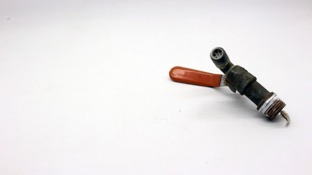 Broken and rusty water tap with white backgroundの写真素材