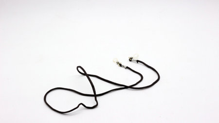 The eyeglass strap is black with a white background.の写真素材