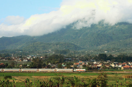 View of a train passing through the countryside with beautiful natural sceneryの写真素材