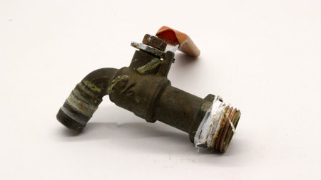 Broken and rusty water tap with white background