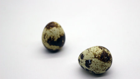 Quail eggs with nice patterns on a white background