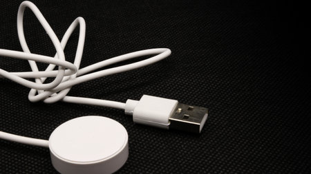 USB charger cable for smart watch isolated on black background