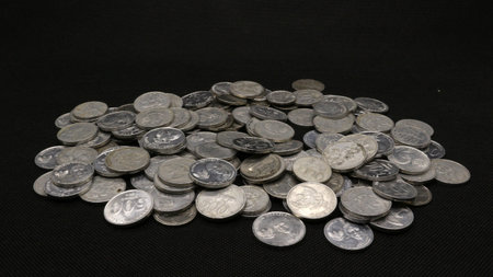 Stack of Indonesian coins isolated on black background