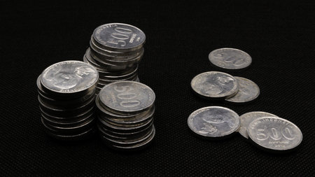 Stack of Indonesian coins isolated on black background