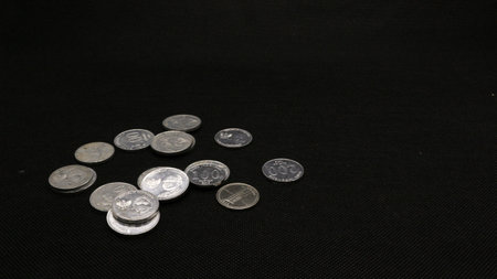 Stack of Indonesian coins isolated on black background