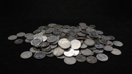 Stack of Indonesian coins isolated on black background