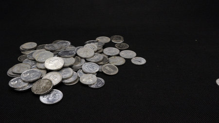 Stack of Indonesian coins isolated on black background
