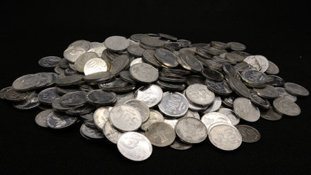 Stack of Indonesian coins isolated on black background
