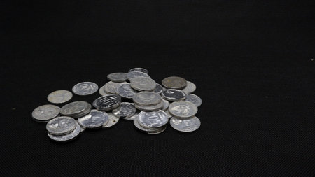 Stack of Indonesian coins isolated on black background