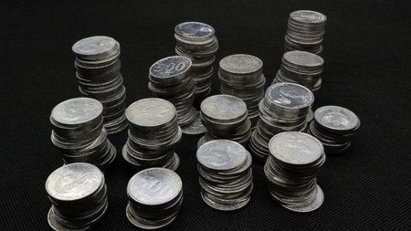 Stack of Indonesian coins isolated on black background