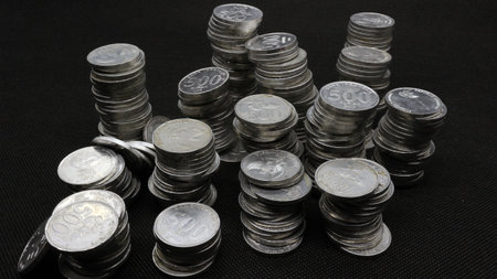 Stack of Indonesian coins isolated on black background