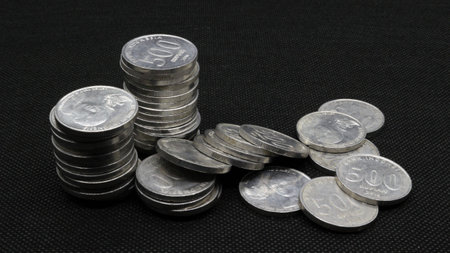 Stack of Indonesian coins isolated on black background