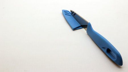 Blue knife with cover isolated on white background